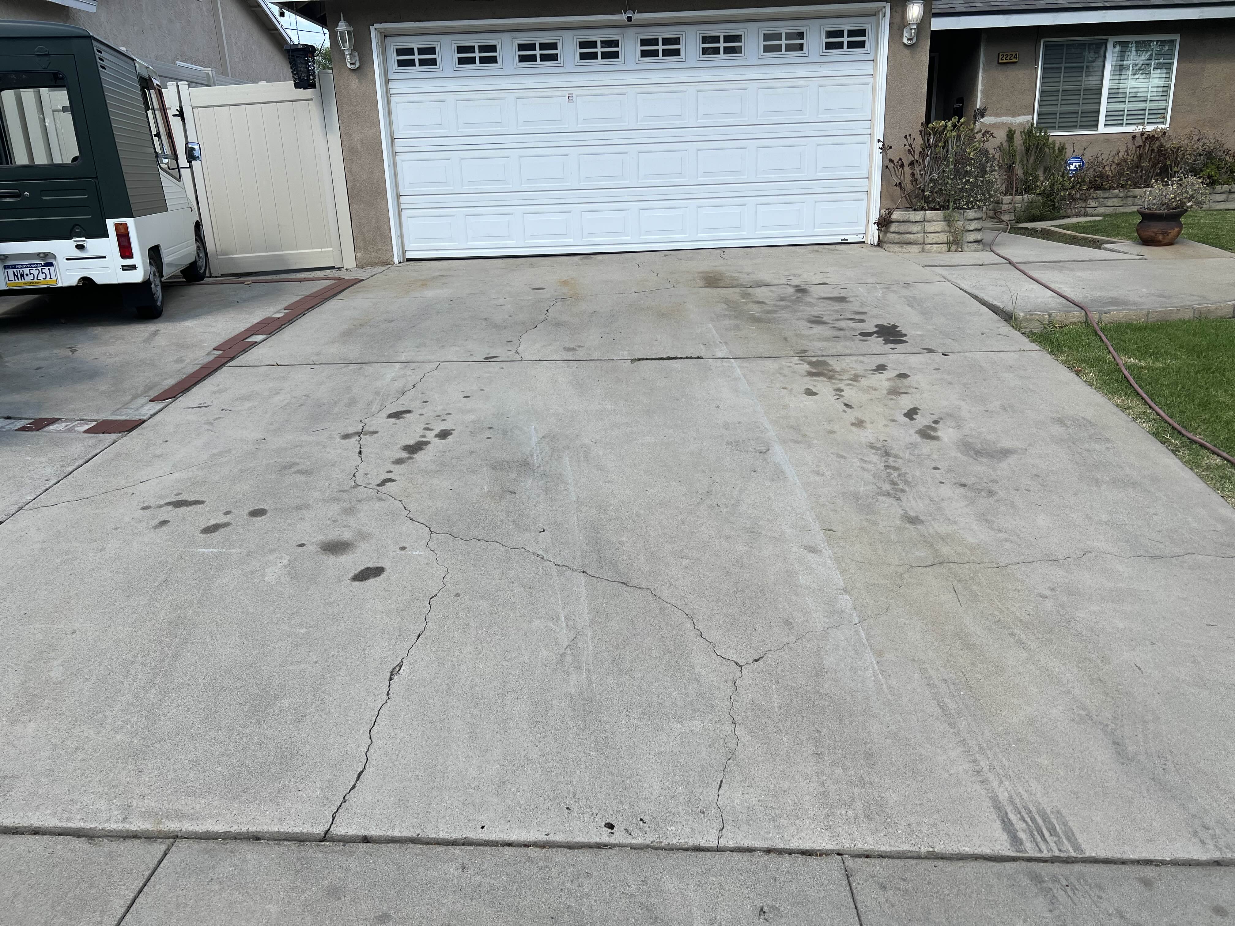 before oil stain removal from driveway